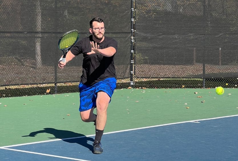 Adult players rallying on court