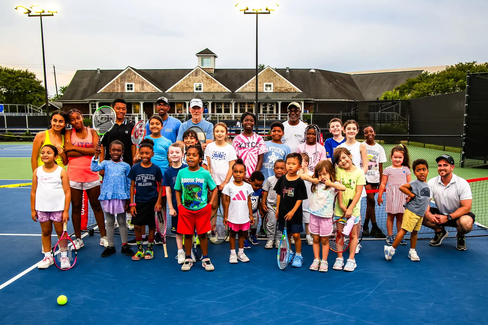 JTCC coaches and young players together on court